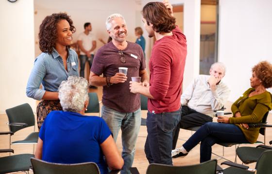 Stock photo group of people socializing after meeting in community center