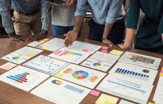 stock-photo-business-documents-on-table-with-multiethnic-hands-working-on-it-closeup-business